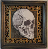 human skull shadowbox with wood outside frame and metal inside